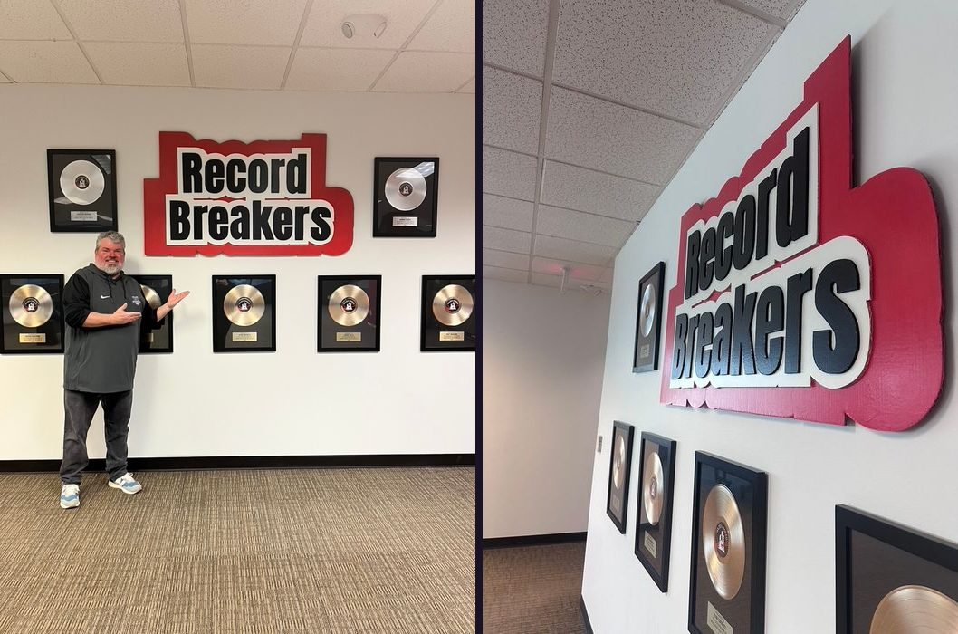 Custom Record Breakers red, white and black 3D wall sign above framed gold records, with the owner standing beside the wall and an angled close-up of the sign