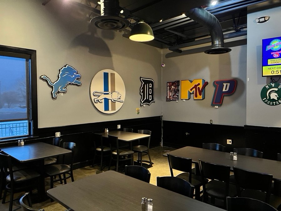 Custom Detroit Lions, retro Lions, Tigers D and Pistons P cutouts on a sports bar wall