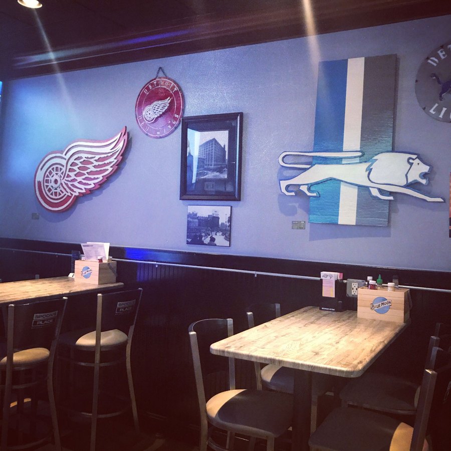 Custom Detroit Red Wings and retro Detroit Lions cutouts on a sports bar wall