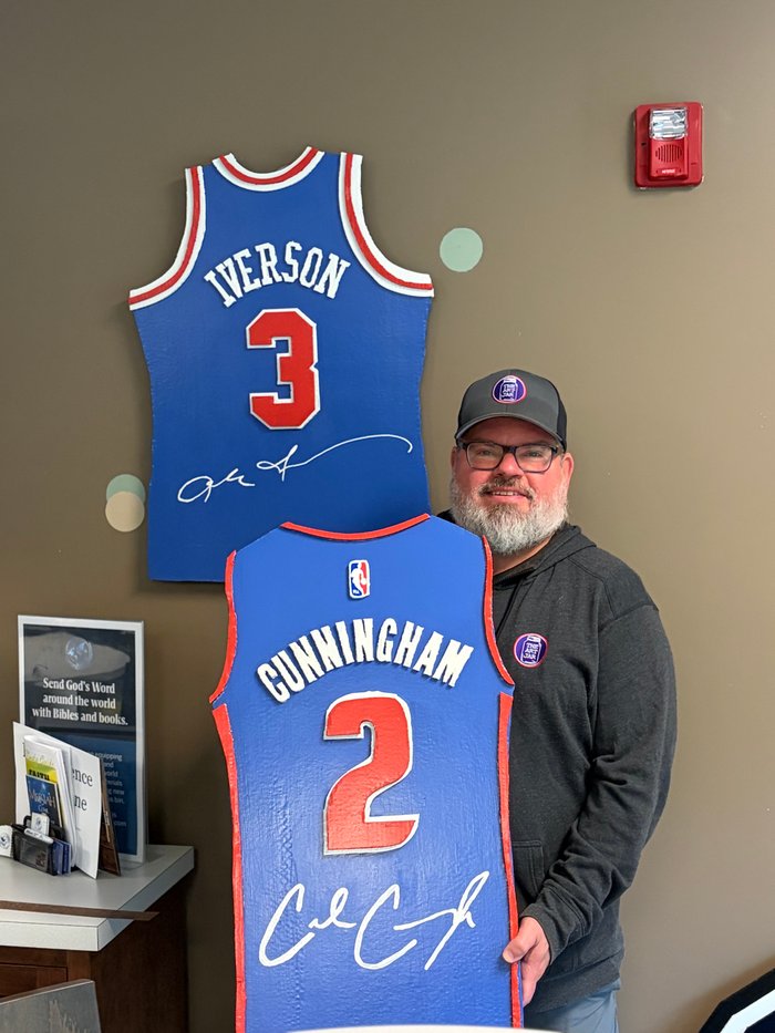 Iverson and Cunningham tribute jersey cutouts mounted on wall