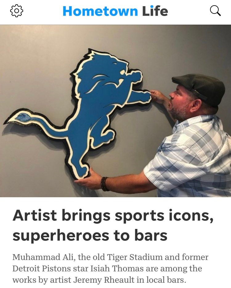Hometown Life article: Artist brings sports icons, superheroes to bars, showing Jeremy hanging a custom Detroit Lions cutout