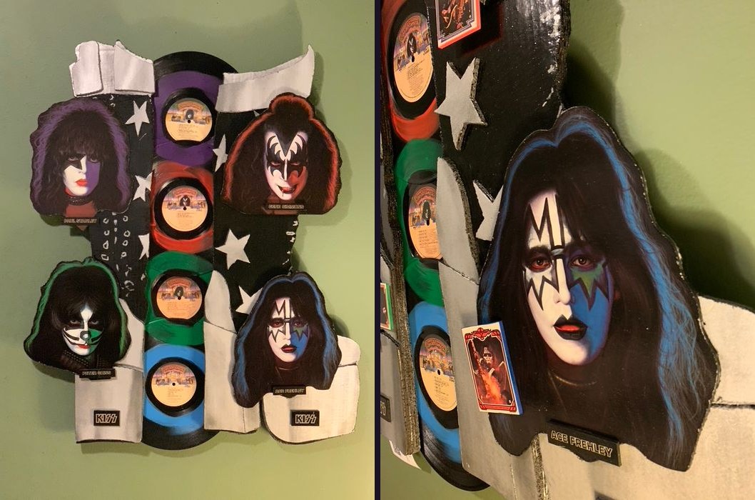 Hand-made KISS sculpture with cut-out solo album faces of Paul Stanley, Gene Simmons, Peter Criss and Ace Frehley, four colored vinyl records and a trading card, front and angled views