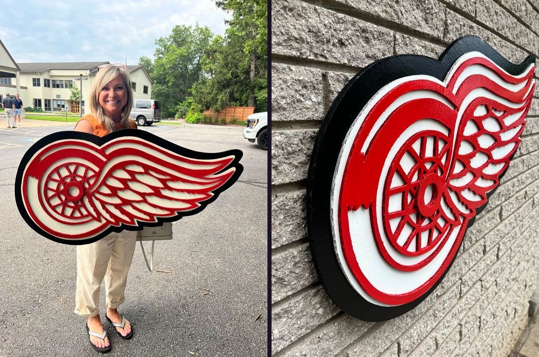 Custom layered Detroit Red Wings logo cutout, held by customer and close-up