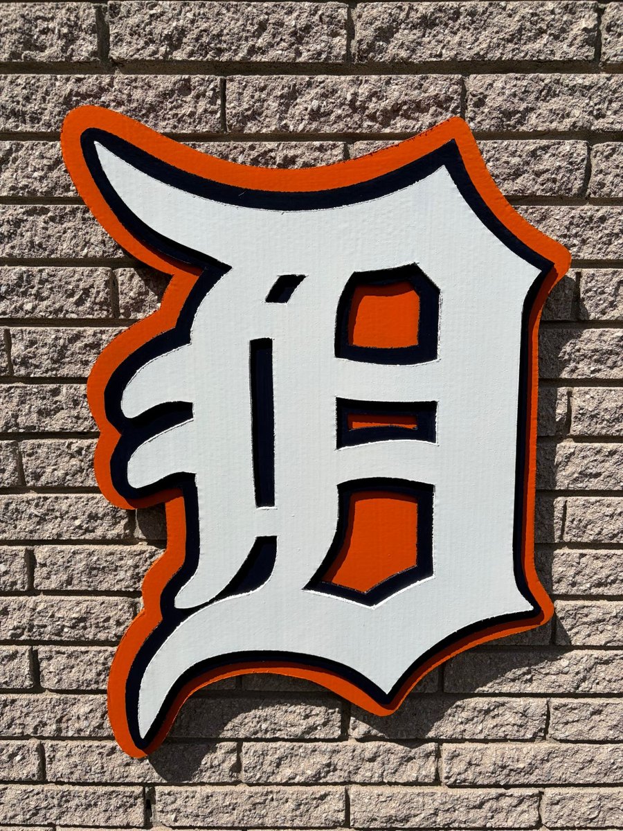 Custom orange, white and navy Detroit Tigers Old English D cutout on brick wall
