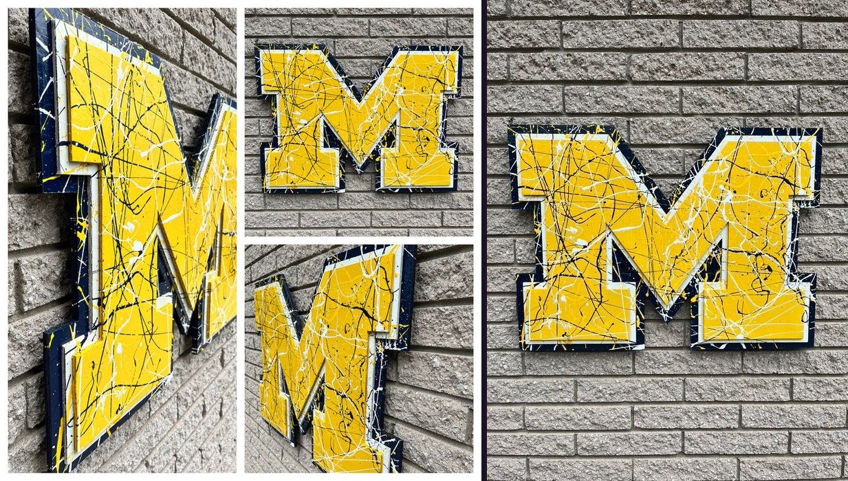 Custom maize Michigan block M cutout covered in navy, black and white splatter paint on a brick wall, collage of close-up angles and the full front view