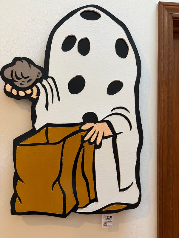 Hand-cut Charlie Brown ghost with a bag of rocks cutout