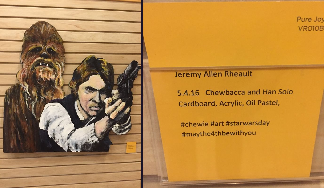 Painted cardboard portraits of Chewbacca and Han Solo next to the gallery card