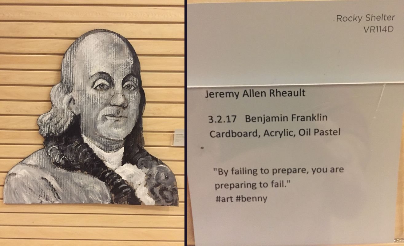Painted cardboard portrait of Benjamin Franklin next to its gray gallery card