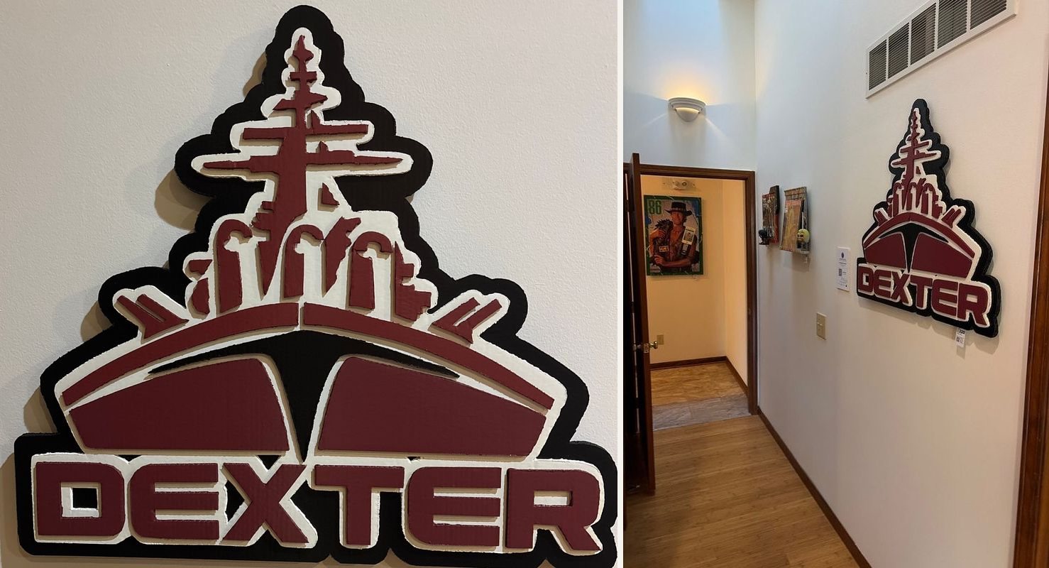 Dexter High School fan art logo cutout, close up and hanging in the hallway at Thomas Arbaugh Farm Bureau Agency