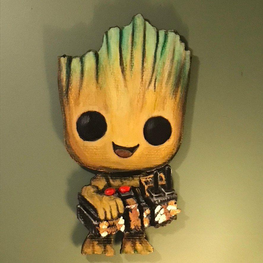 Hand-cut and hand-painted Funko Pop style Baby Groot holding a game controller, on a green wall