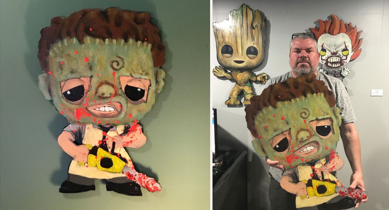 Hand-cut and hand-painted Funko Pop style Leatherface in a stitched green mask with a bloody chainsaw, on a green wall, and held by the artist in his studio