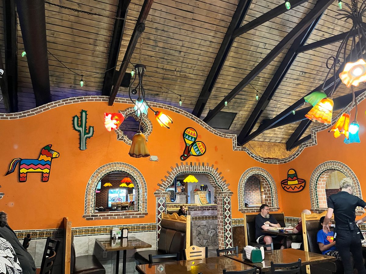 Beamed ceiling and orange wall at Los Amigos with the piñata, cactus and hand-cut pieces