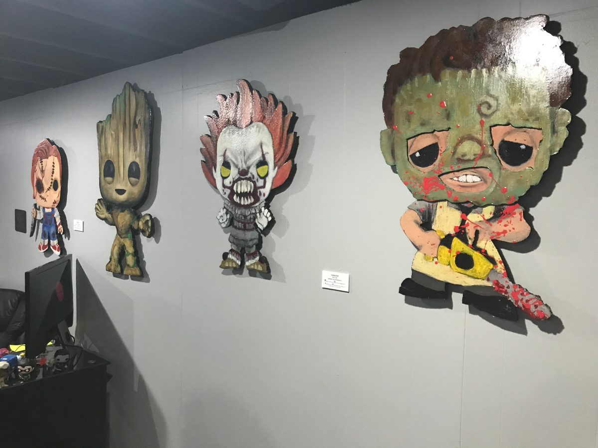 Chucky, Groot, Pennywise and Leatherface Funko-style cutouts hung along the wall at Popgodz, with the shop counter behind