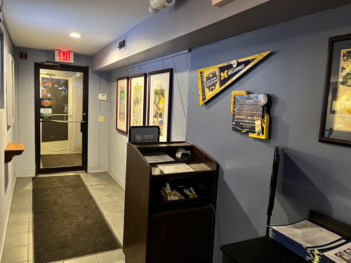 The hall by the entrance with the pennant, the framed team photo and framed prints