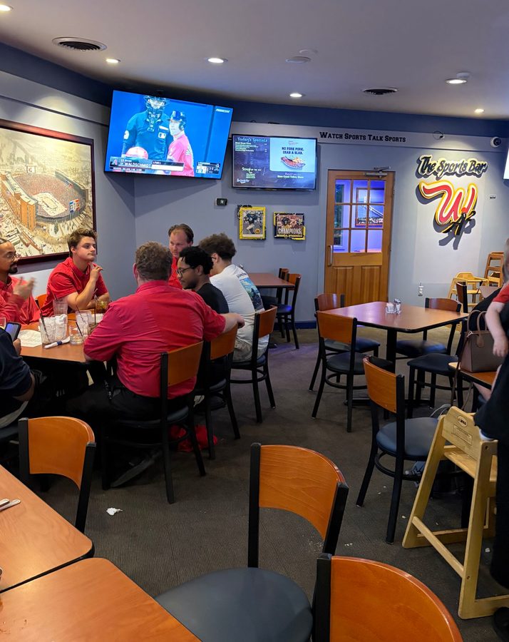 The Sports Bar lettering above the W logo, with two framed Champions pieces on the wall