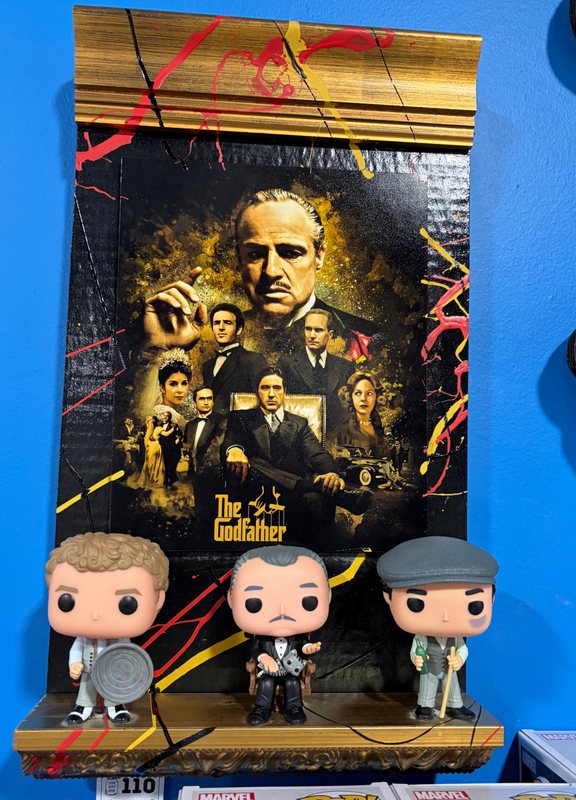 Hand-embellished The Godfather poster art with splatter paint and three Godfather Funko Pops on a shelf